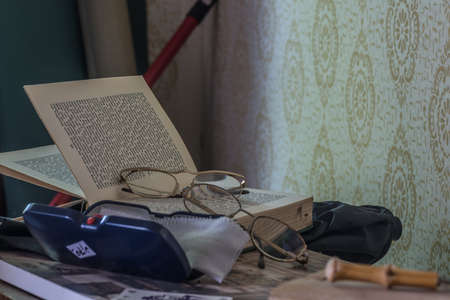 two glasses and a case with a book in a room from a abandoned houseのeditorial素材