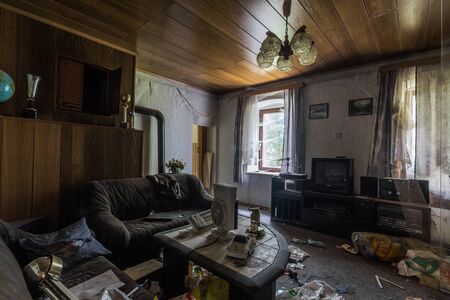 abandoned living room with many objects in the countryの写真素材
