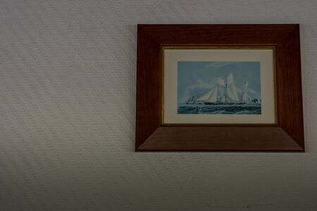 picture with a sailing ship on the wall on a shipの写真素材