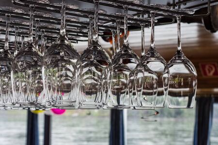 clear hanging glasses at a bar at a old shipの写真素材