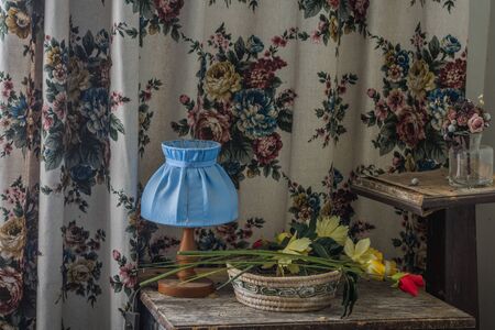 blue lamp flowers and a curtain in a abandoned houseの写真素材