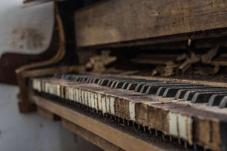 dusty keys from a piano in a old abandoned houseの写真素材