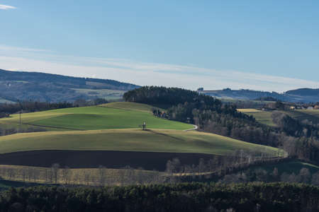 green landscape with hills and fields in springの写真素材