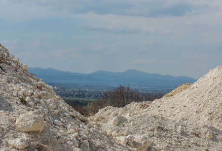 white lime quarry with a landscape with a mountain in the middle
