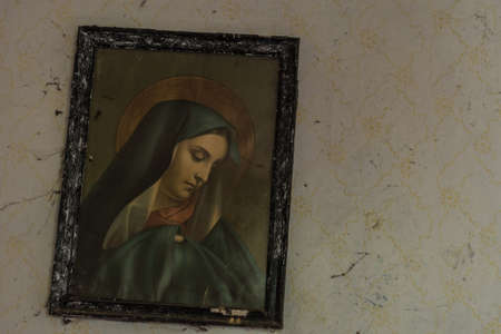 oblique hanging holy picture on the wall from a old house