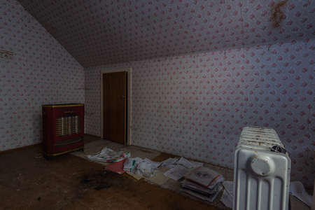 attic with old heater in a abandoned house in the countryの写真素材