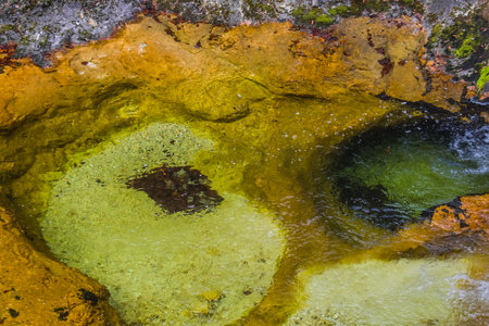 green orange basin with cold clear water from a torrent in the mountainsの写真素材