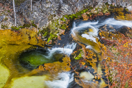 colorful cascades waterfall with basin in the mountains while hikingの写真素材
