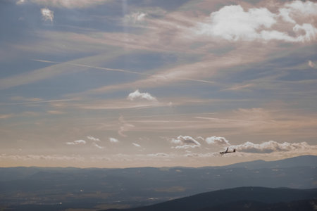 glider on the sky with different clouds while hiking