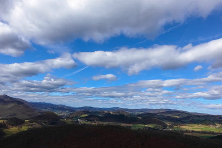 beautiful clouds on blue sky and wide view to mountains and valleys while hiking
