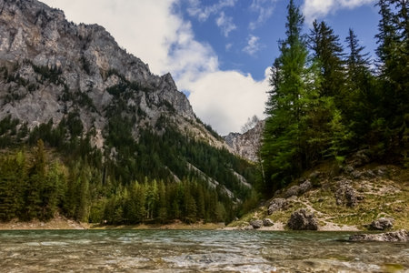 beautiful lake in the mountains while hiking in the spring and warm weatherの写真素材