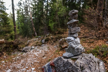 stacked stones on a path while hiking in austrian mountains