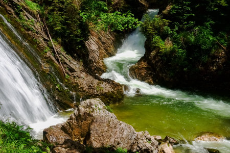 wonderful nice place with waterfalls and clear rushing water in the mountainsの写真素材