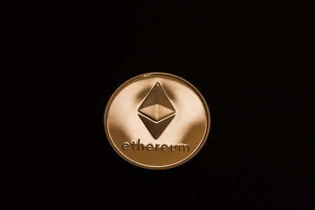 shining gold ether coin from cryptocurrency middle on black background