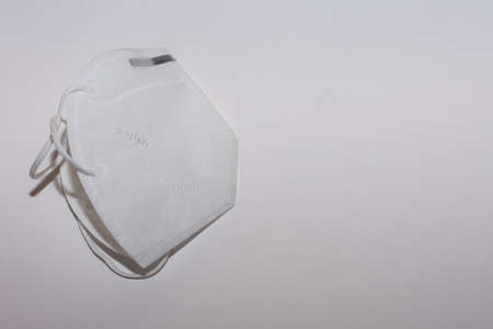 single white FFP2 or KN95 mask on white background left view