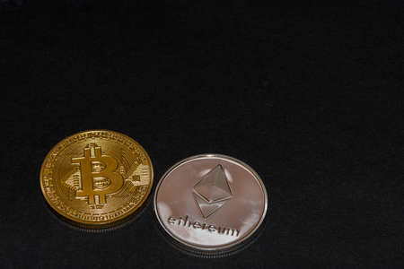two valueable coins bitcoin and ether from cryptocurrency on black background