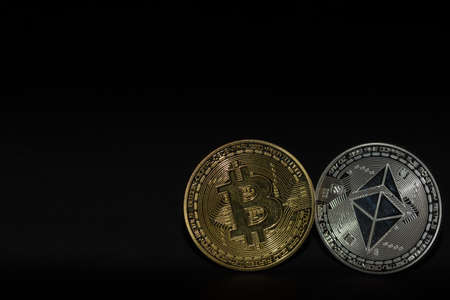 single bitcoin and ether coin with black background bottom right viewの写真素材
