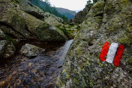 sign from austria on a rock with a mountain stream while hikingの写真素材