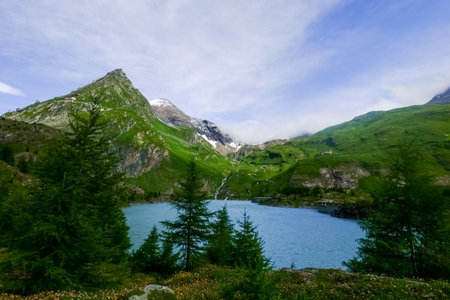 wonderful blue lake from a hydroelectric power plant in the mountain nature while hiking