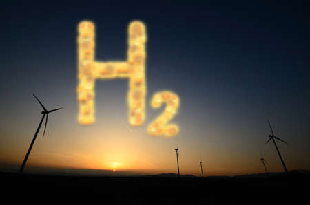 hydrogen h2 letters and wind turbines at the sunset