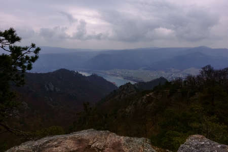 standing at a viewpoint with rocks with view to a wide landscape in the springの写真素材