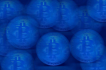 valueable many blue bitcoin crypto currency_with blue backgroundの写真素材