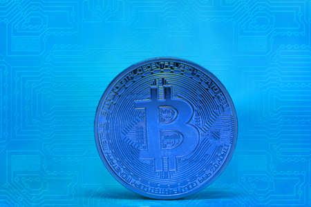single blue bitcoin coin with blue electrical circuit diagram
