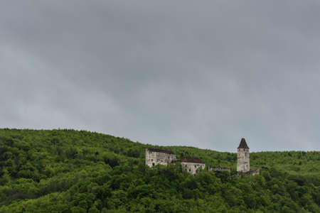 old castle in green hills and rain clouds while hikingのeditorial素材