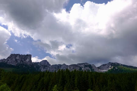 wonderful rugged mountains and white clouds on the sky while hiking in austria