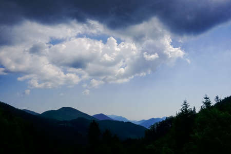 dark clouds at the sky before rain while hiking in the mountains on vacation