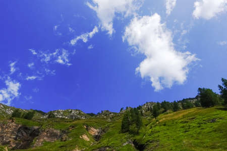 amazing blue sky with soft white clouds in the mountains from austriaの写真素材