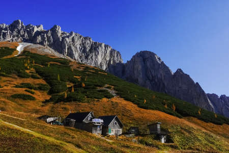 alpine huts in the middle from a mountain range in austria on vacationの写真素材