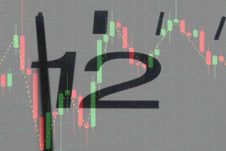 clock with five before twelve and a colorful chart from the stock market in the background