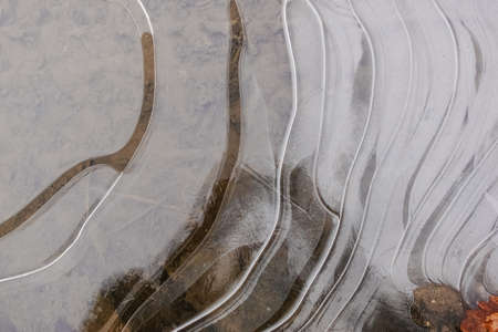 frozen puddle with air pockets and kreative round forms in the winter