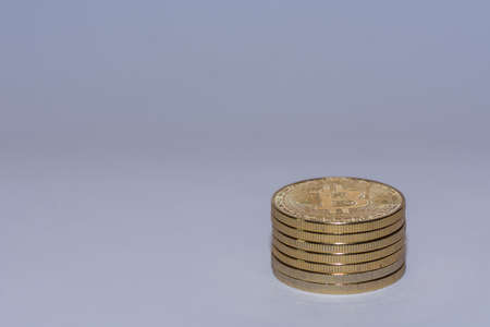 stack of golden valueable bitcoins from crypto currency with gray background