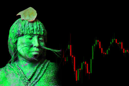green maja sculpture and a colorful chart from the market with black backgroundの写真素材