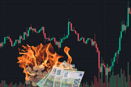 inflation in the world chart from the market with many burning 100 euro bills and coins with black backgroundの写真素材