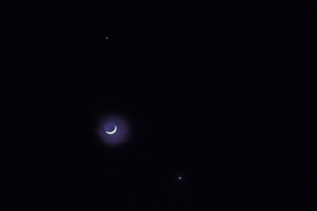 shining moon and two stars next to it at the black sky in the nightの写真素材