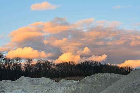 amazing colorful clouds at the sky during sundown in a white lime quarryの写真素材