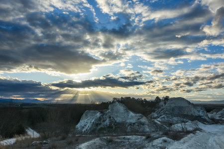 lime quarry with a shining sun an amazing clouds at the blue skyの写真素材