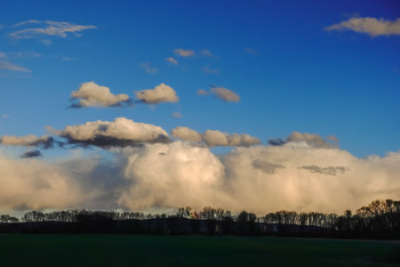 dense clouds from a storm and dark blue sky in a flat landscapeの写真素材
