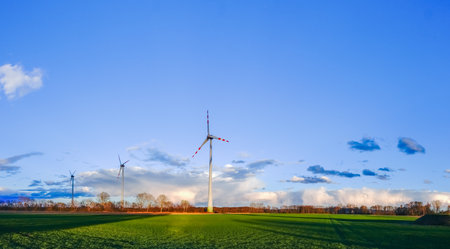 three windmills for clean energy and wonderful colorful landscape with blue sky panorama viewの写真素材