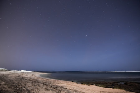 blue warm starry sky with beach at the red sky in egyptの写真素材