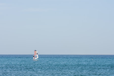 single windsurfer in blue water and blue sky on vacation in egyptの写真素材