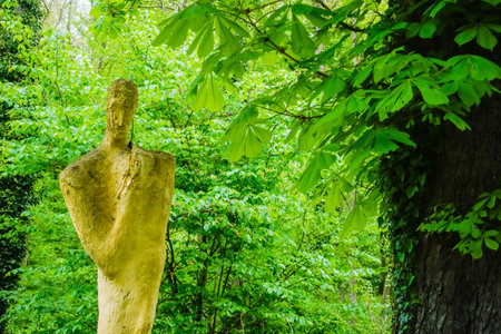 creative statue made of stone in a green forest near a old monasteryの写真素材