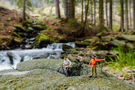 small miniature figures on a rock with a brook in the natureの写真素材