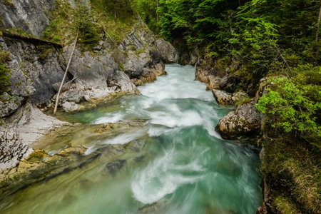 fast flowing torrent between rocky walls in hinterstoder upper austriaの写真素材