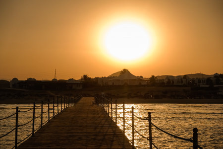 bright sundown over the resort with a jetty on vacation in egyptの写真素材