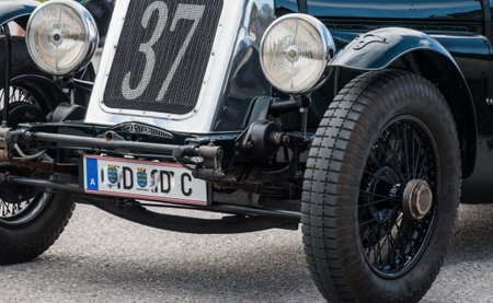 front view from a very old black classic car with the number thirtyseven during a car showの写真素材