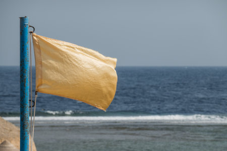 yellow flag at the beach on vacation in egypt detail view